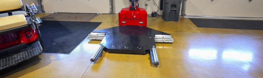 The CarCaddy Vehicle Puller a Powered Vehicle Mover charging at the wall.