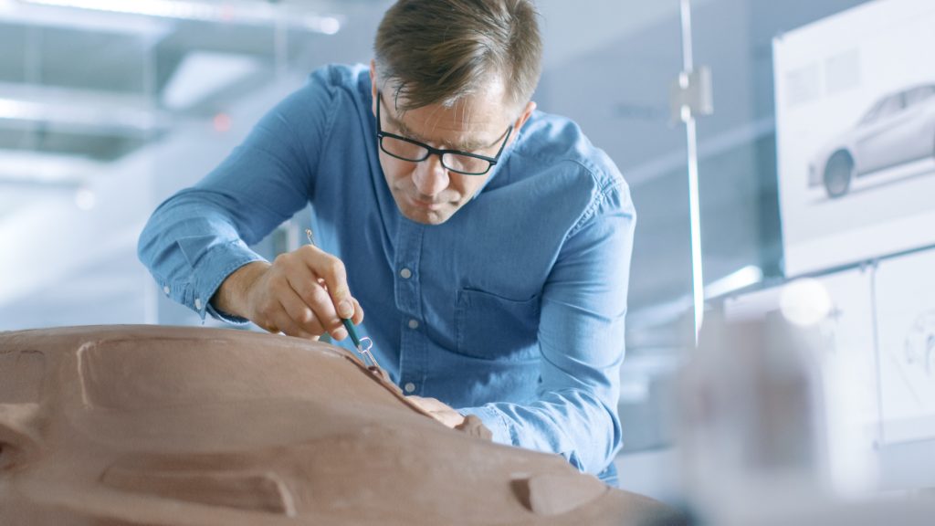 A Vehicle Designer Sculpting a Car From Clay.