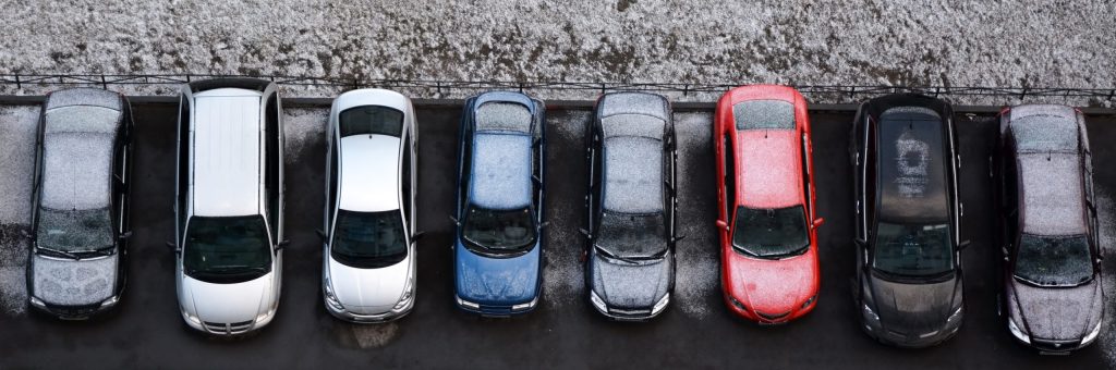 A crowded vehicle impound lot in need of an electric vehicle mover.